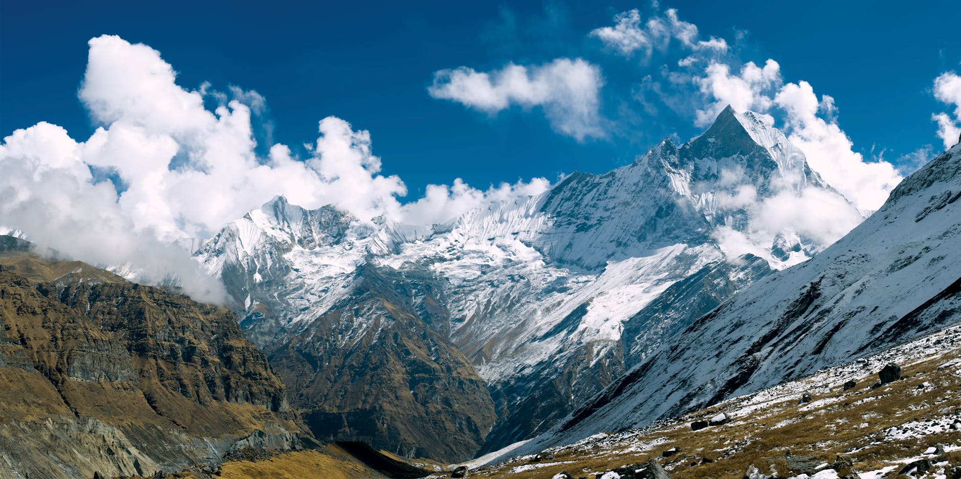 photo of mountains under clouds